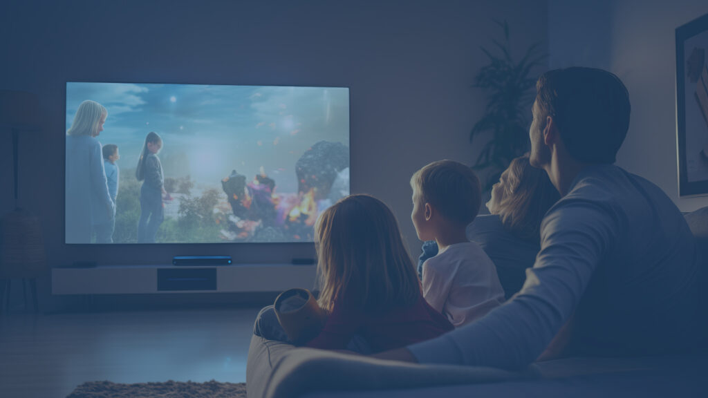 Family watching television on a couch.