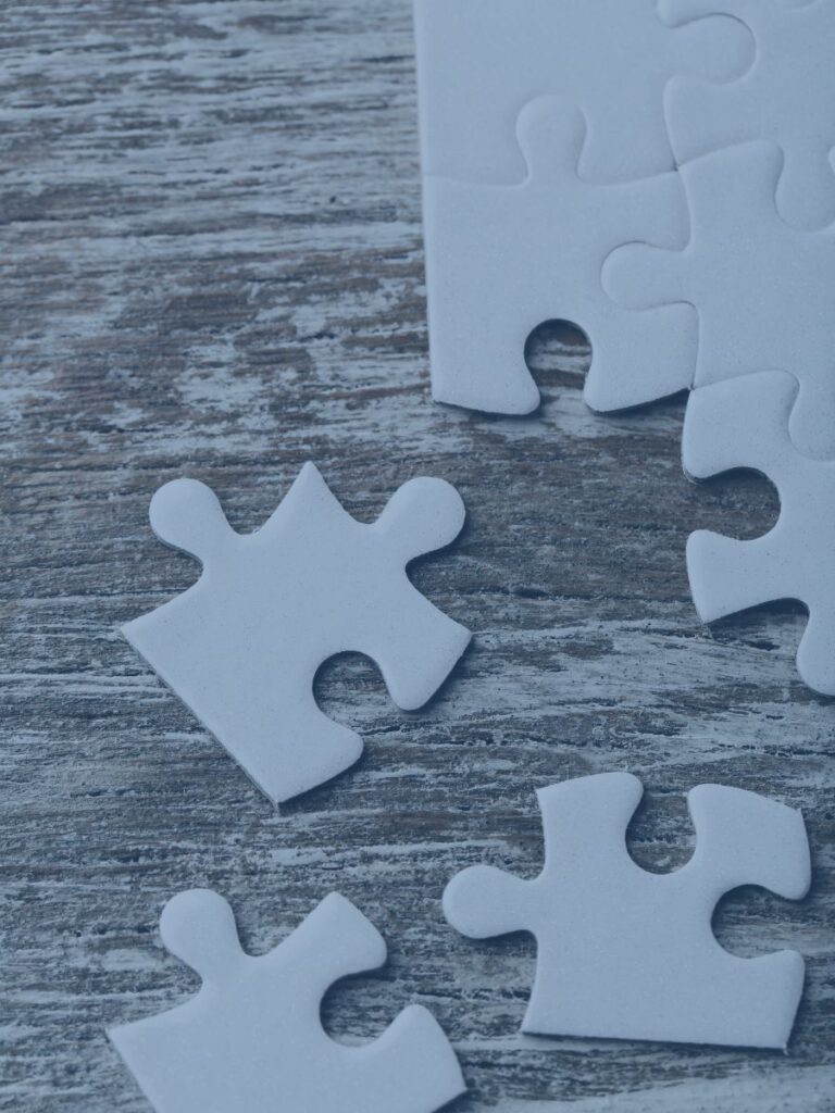 Blank puzzle pieces fitting together.