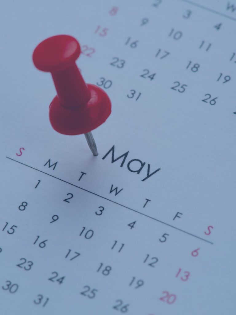 Calendar with red pin next to May.